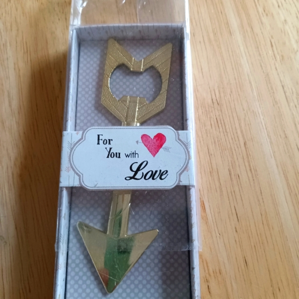 Fashion craft gold colored arrow shaped metal bottle opener.